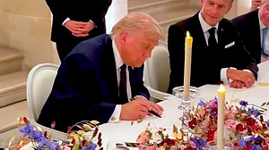 Donald Trump signs Iran MoU at Palace of Versailles in France.