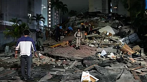 People walk amid debris after an earthquake in Caracas, Venezuela.
