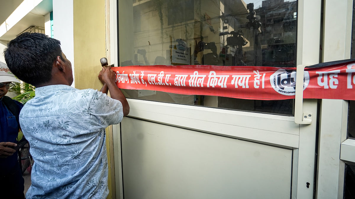 An administration official seals Allen Coaching in Hazratganj area.