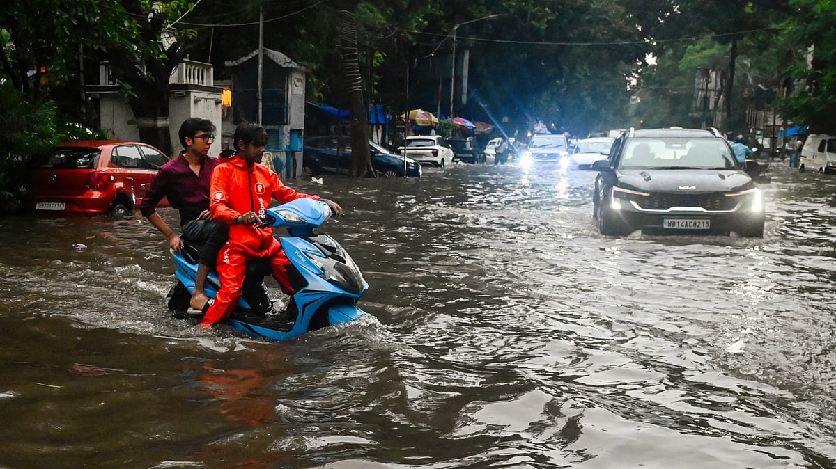 Kolkata: Vehicles wade through a waterlogged road in Kolkata, 25 June 25