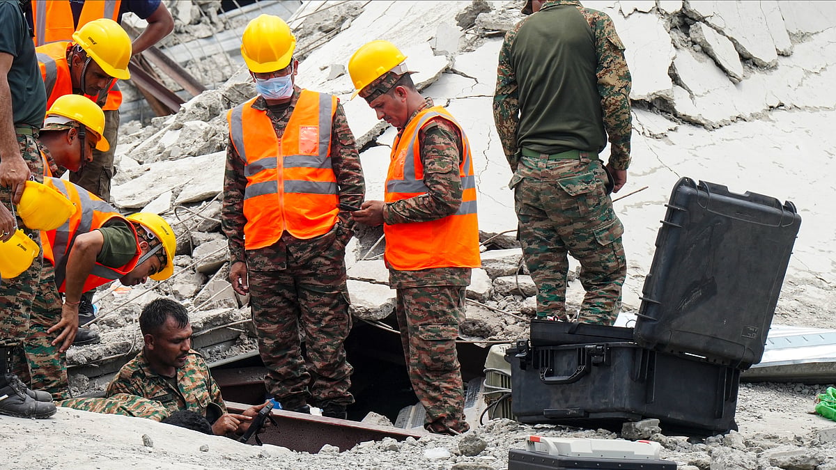 Officials conduct a search operation at the collapse site in Kolkata.