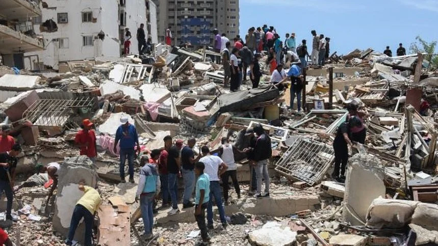 Residents search through the rubble for their belongings in Venezuela.