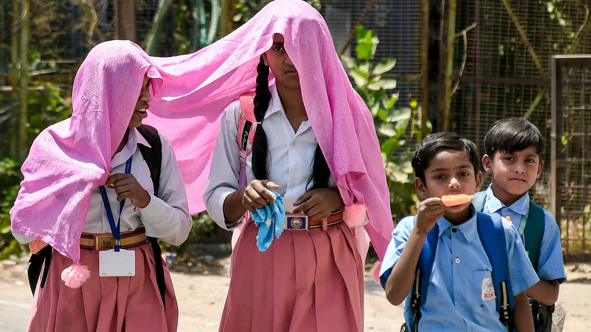 Students brave the scorching heat as they return from school in Prayagraj.