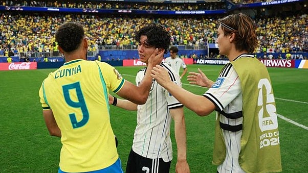 Hard luck: Japan's midfielder Ao Tanaka being consoled by Brazil's Cunha after the game