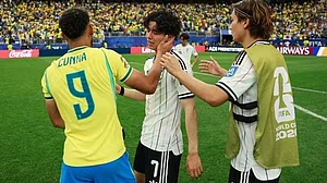 Hard luck: Japan's midfielder Ao Tanaka being consoled by Brazil's Cunha after the game