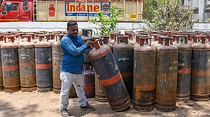 A gas agency worker with an LPG cylinder in Surat.