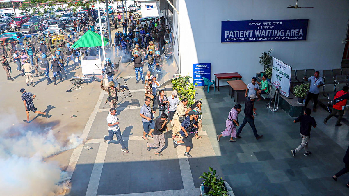 Security personnel fire tear gas during a protest outside RIMS Hospital in Imphal.