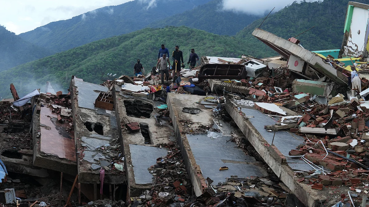 Residents search the rubble of a building destroyed in Venezuela earthquakes.