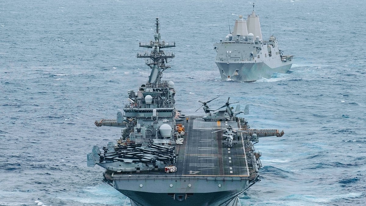 Warships sail through the Strait of Hormuz amid heightened regional tensions.