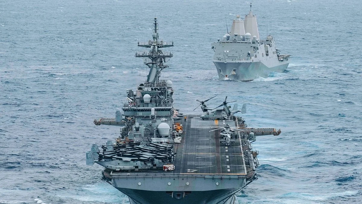 Warships sail through the Strait of Hormuz amid heightened regional tensions.