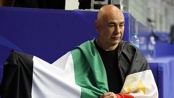 Egypt coach Hassam Hassan with both Palestine and Egyptian flags