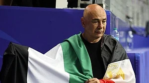 Egypt coach Hassam Hassan with both Palestine and Egyptian flags