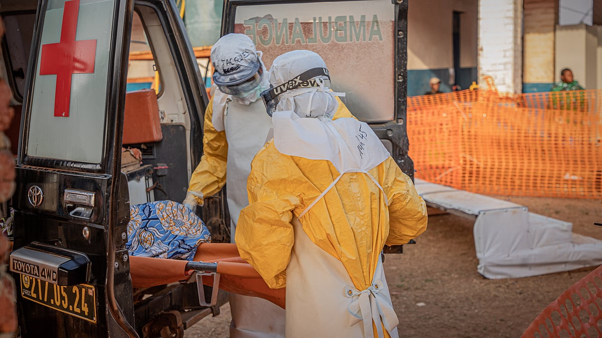 Medical workers escort an Ebola patient to a treatment center in DR Congo.
