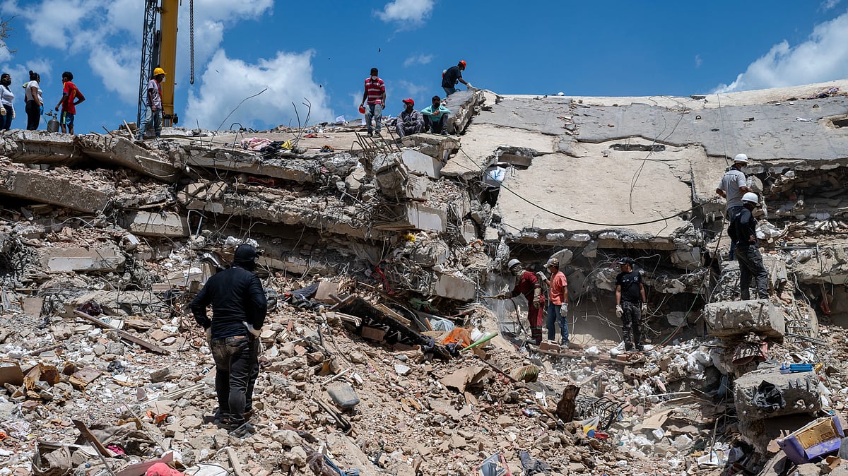 Rescue workers search debris at a collapsed building in Catia la Mar, Venezuela.