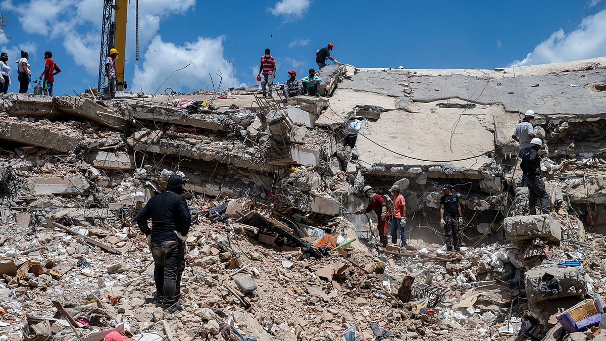Rescue workers search debris at a collapsed building in Catia la Mar, Venezuela.