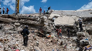 Rescue workers search debris at a collapsed building in Catia la Mar, Venezuela.