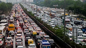 Vehicles crawl through waterlogged roads as heavy rain triggers massive traffic jams across Gurugram.