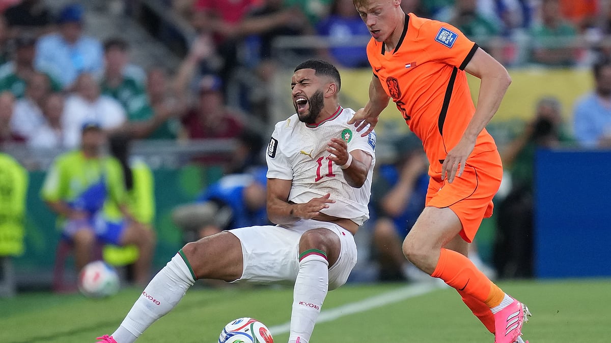 Netherlands' Jan Paul van Hecke (R) challenges Morocco's Ismael Saibari during WC Round of 32.
