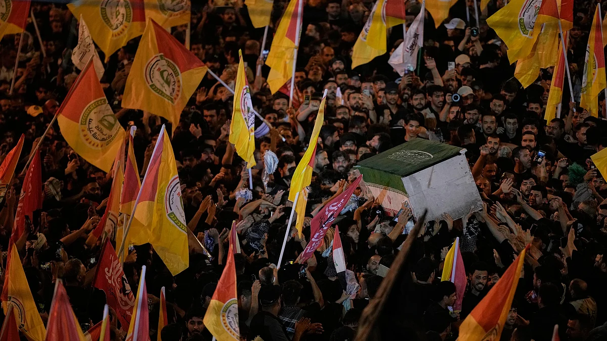 Mourners jostle to touch Ali Khamenei's coffin in Karbala.
