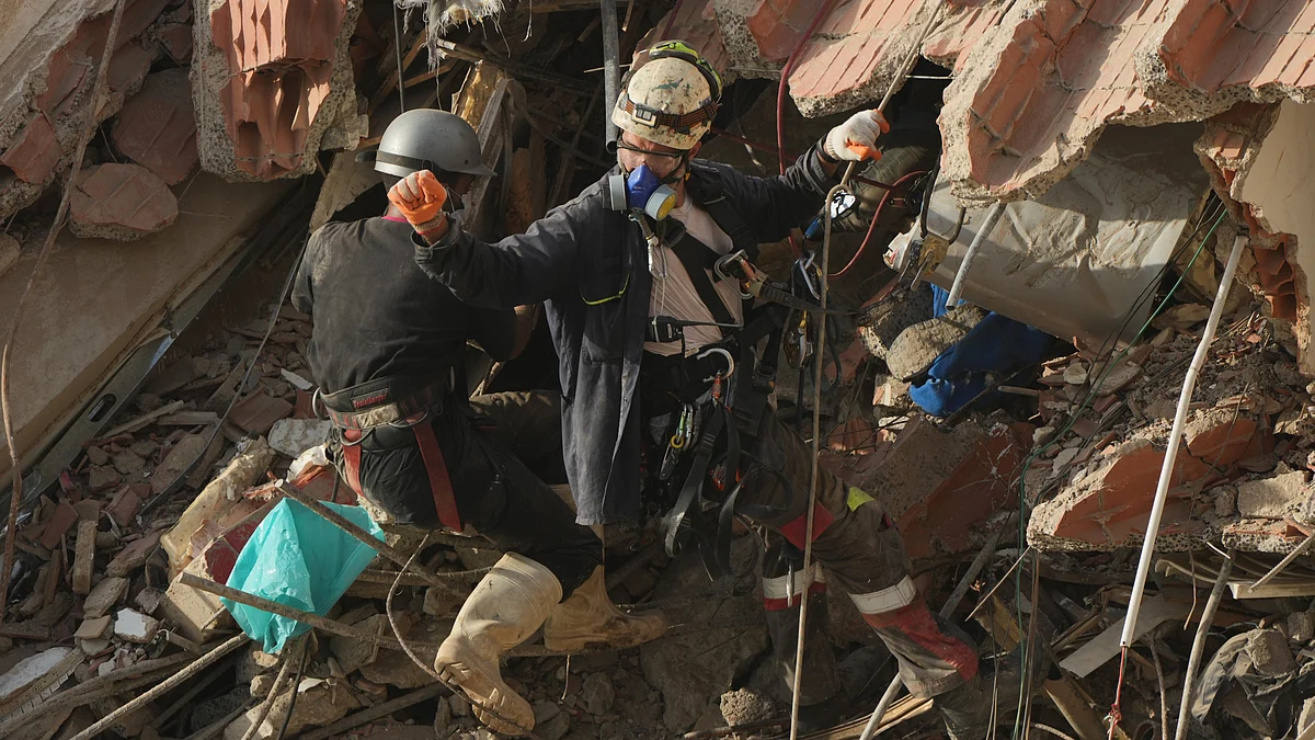Rescue workers search through the rubble of earthquake-damaged buildings in La Guaira, Venezuela.