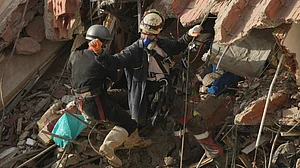 Rescue workers search through the rubble of earthquake-damaged buildings in La Guaira, Venezuela.