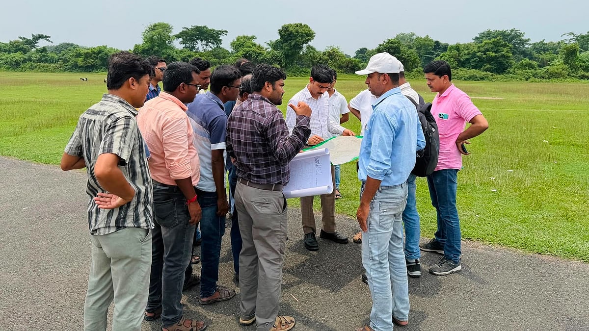 Officials inspect the proposed alignment for the runway in Malda.