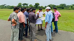 Officials inspect the proposed alignment for the runway in Malda.