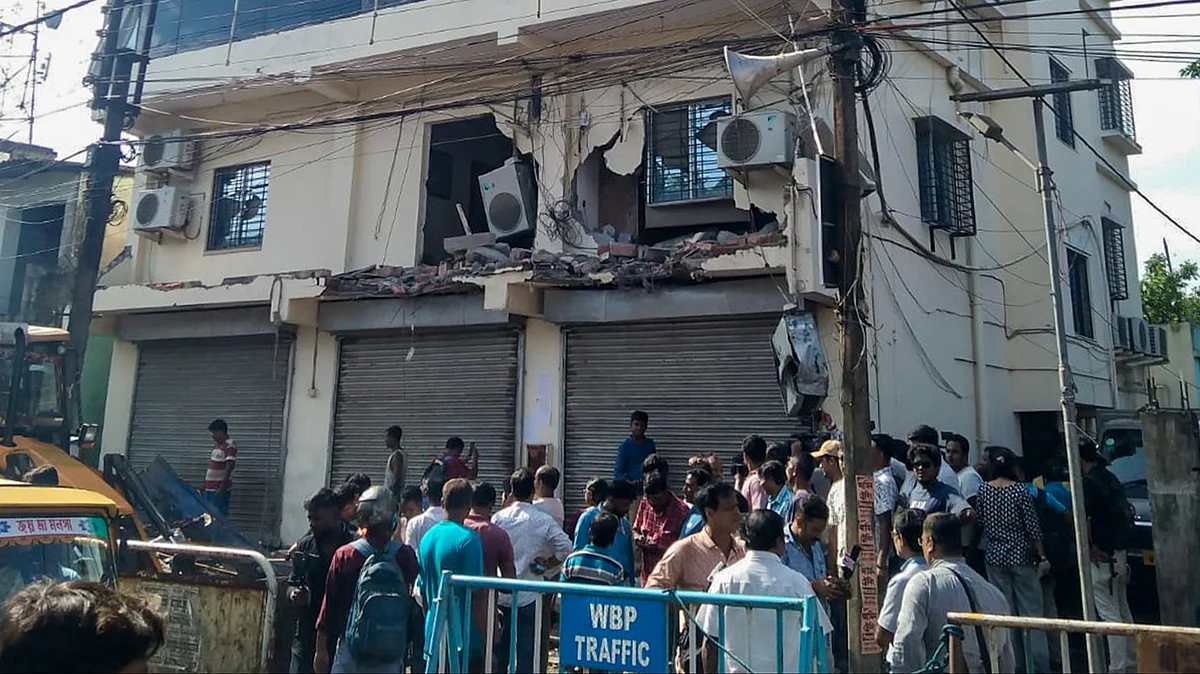 People gather as Abhishek Banerjee’s TMC office is demolished in Amtala.