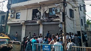 People gather as Abhishek Banerjee’s TMC office is demolished in Amtala.