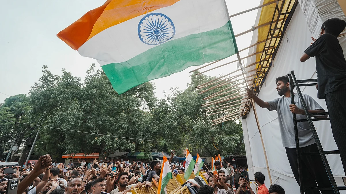 CJP founder Abhijeet Dipke waves the national flag during a protest.