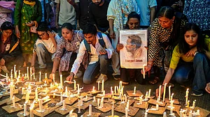 Activists and students light candles during a vigil in solidarity with Sonam Wangchuk in Nagpur, 18 July