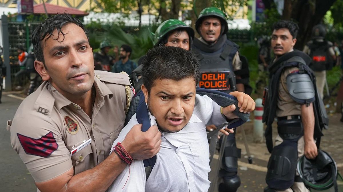 Security personnel stop a CJP supporter near Jantar Mantar during a protest march
