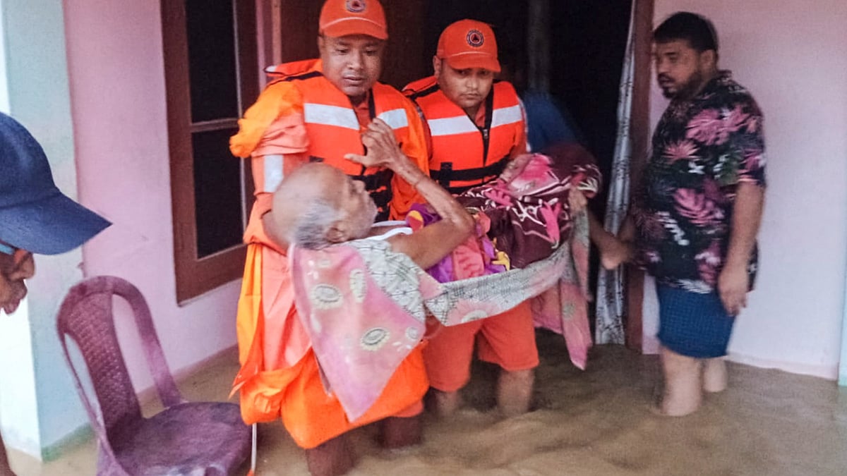 NDRF officials conduct rescue operation in a flood-affected area in Assam.