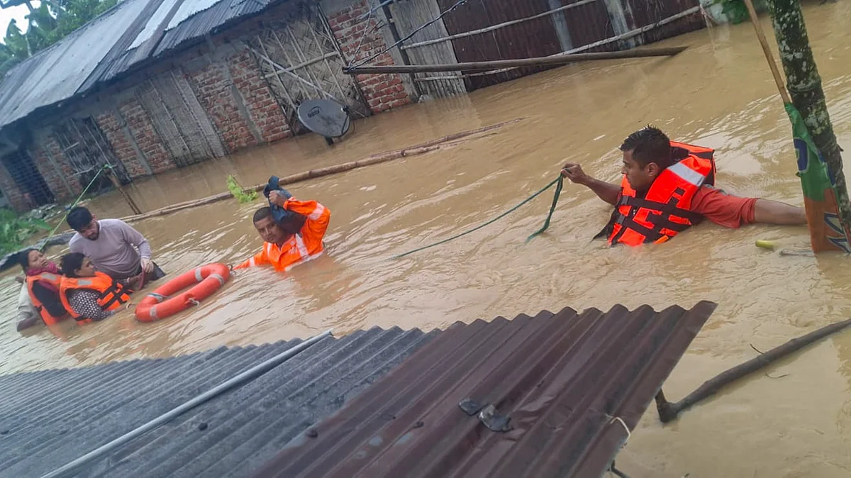 NDRF officials conduct rescue operation in a flood-affected area in Assam.