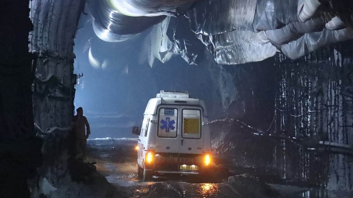 An ambulance carries trapped victims through the collapsed tunnel.