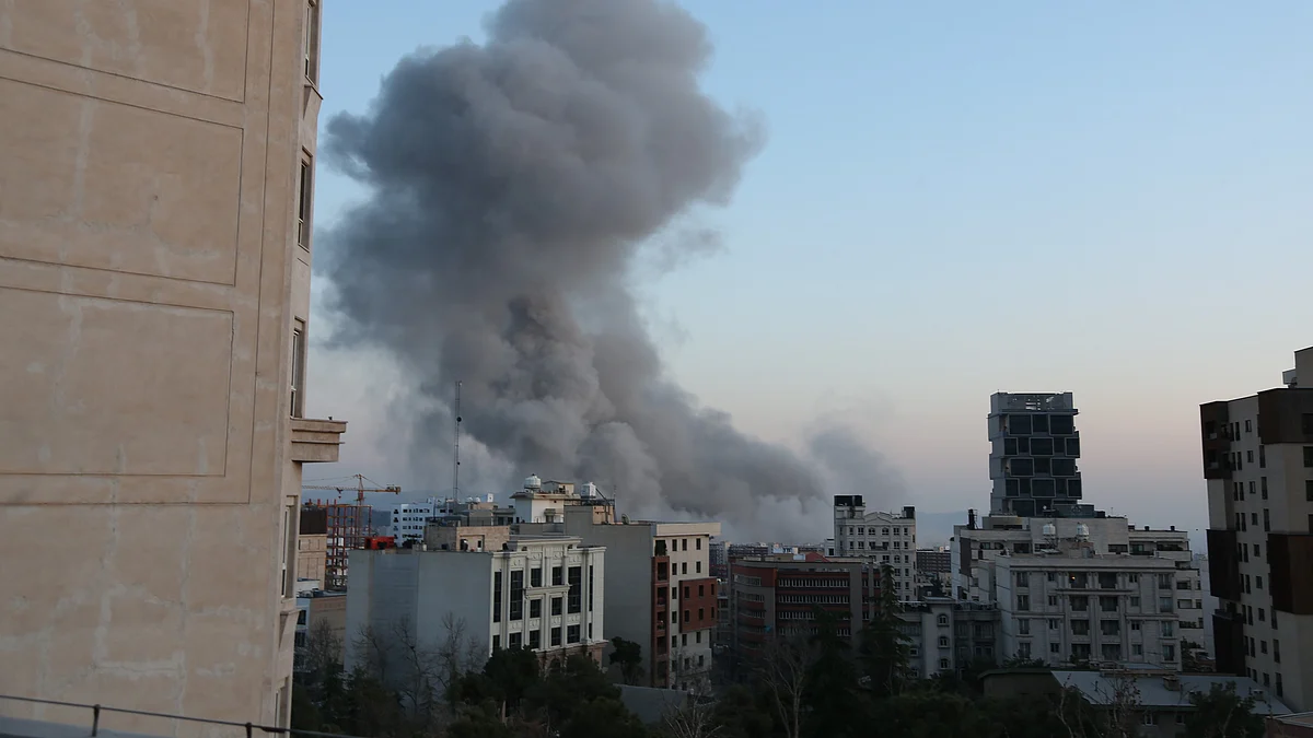 Smoke billows over Tehran following an explosion amid ongoing US strikes.