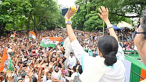 Mamata Banerjee waves to supporters from the dais