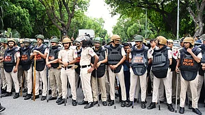 Delhi Police personnel on guard the day after clashes with protesters, 21 July