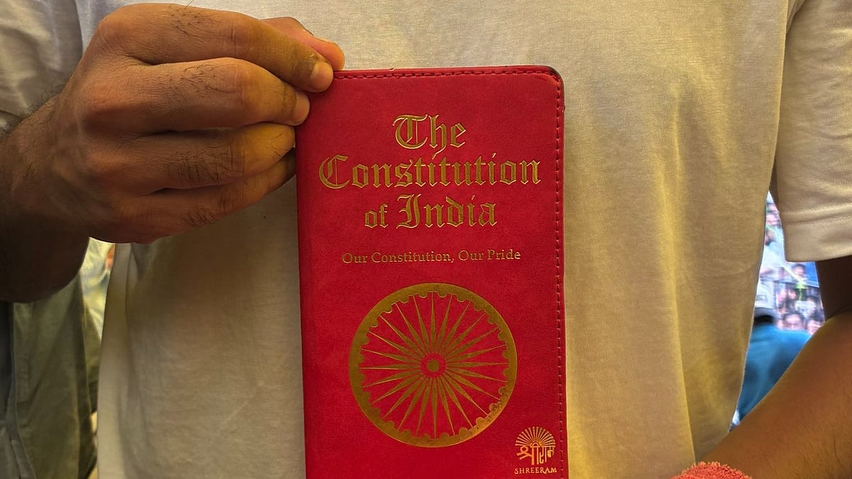 Abhijit Dipke holds the constitution in his hand at Jantar Mantar