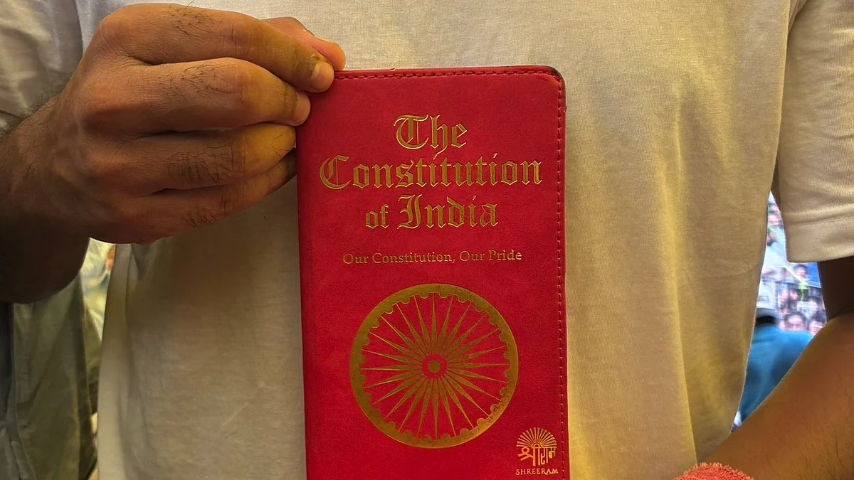 Abhijit Dipke holds the constitution in his hand at Jantar Mantar