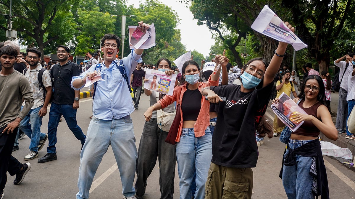 Youngsters celebrate the resignation of Dharmendra Pradhan