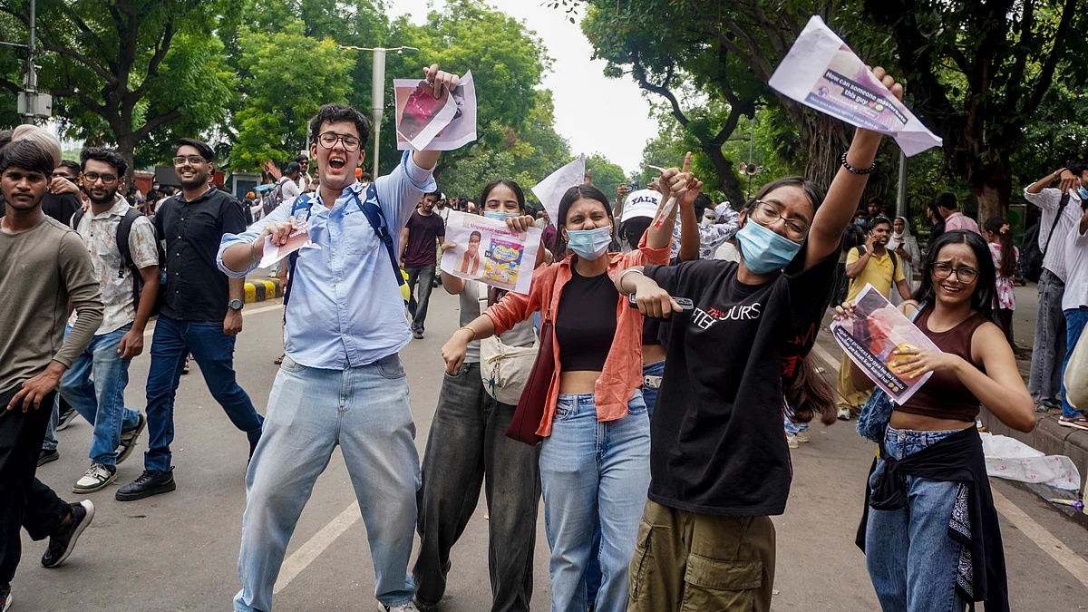 Youngsters celebrate the resignation of Dharmendra Pradhan