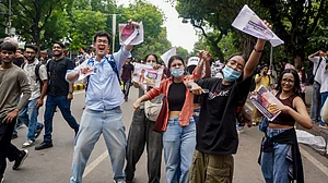 Youngsters celebrate the resignation of Dharmendra Pradhan