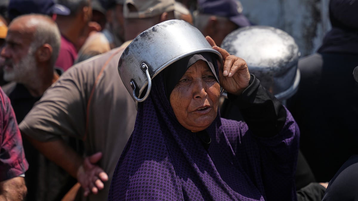 Displaced Palestinians await food aid in Khan Younis, Gaza.