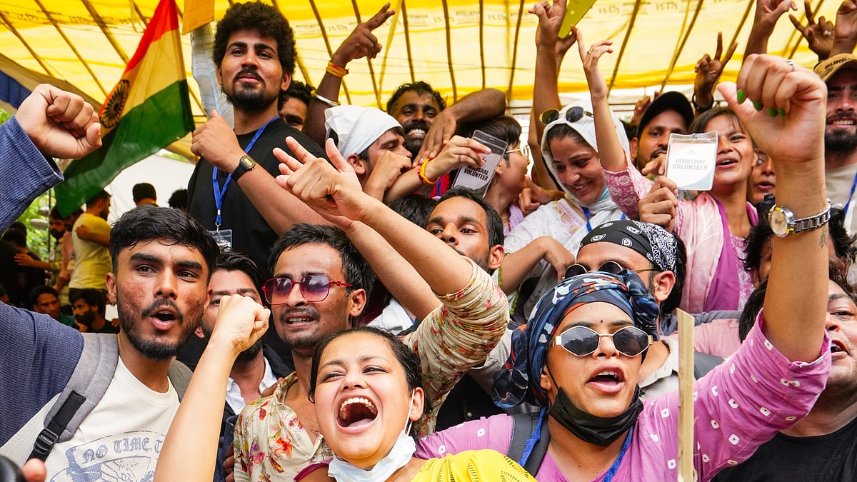 Protesters celebrate after the resignation of Dharmendra Pradhan, at Jantar Mantar, 25 July