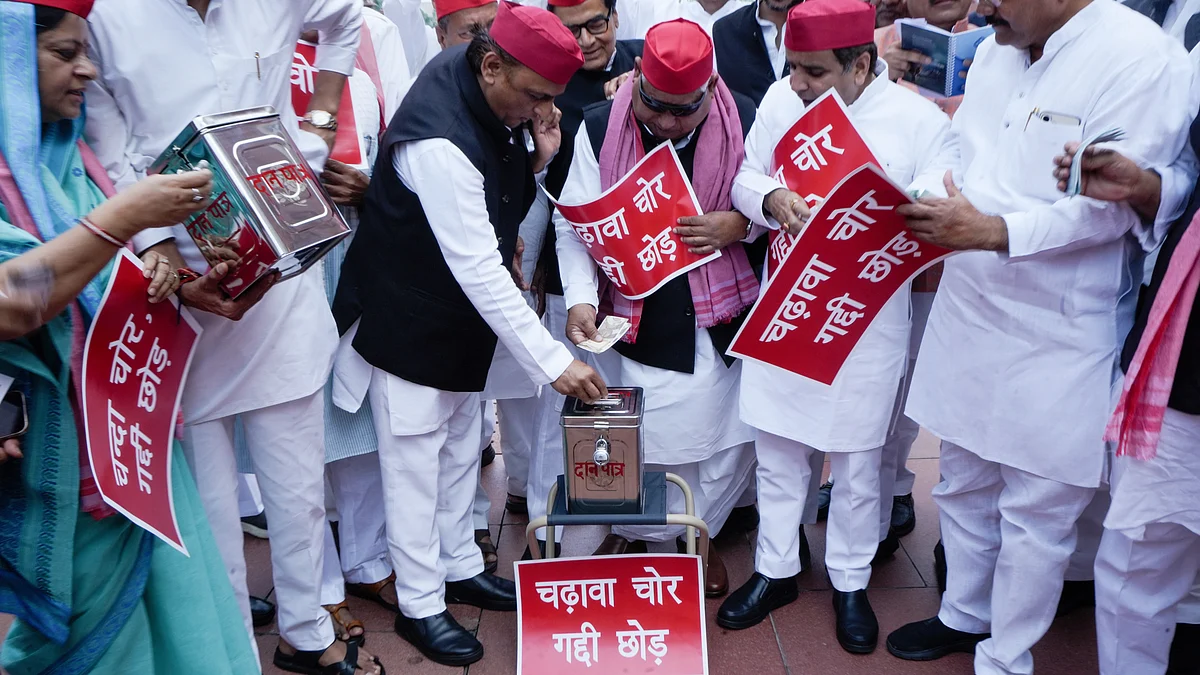 Akhilesh Yadav (L) and party MPs protest the donation row, outside Parliament, 29 July