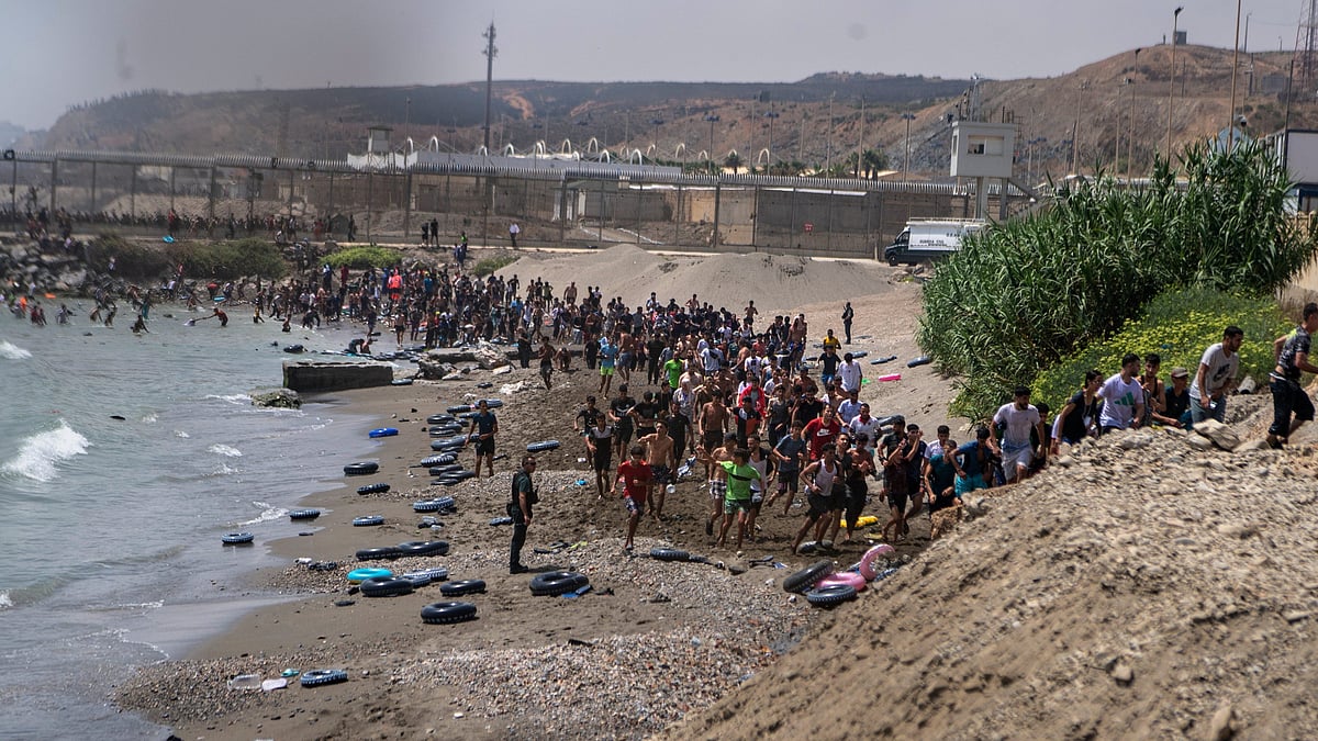 Migrants crossing from Morocco into the Spanish enclave of Ceuta