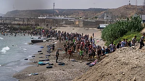 Migrants crossing from Morocco into the Spanish enclave of Ceuta