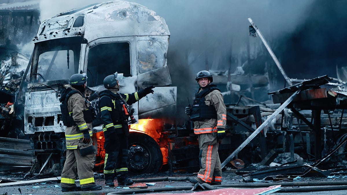 Rescue workers at a mail sorting centre after a Russian strike in Zaporizhzhia, Ukraine, 25 July