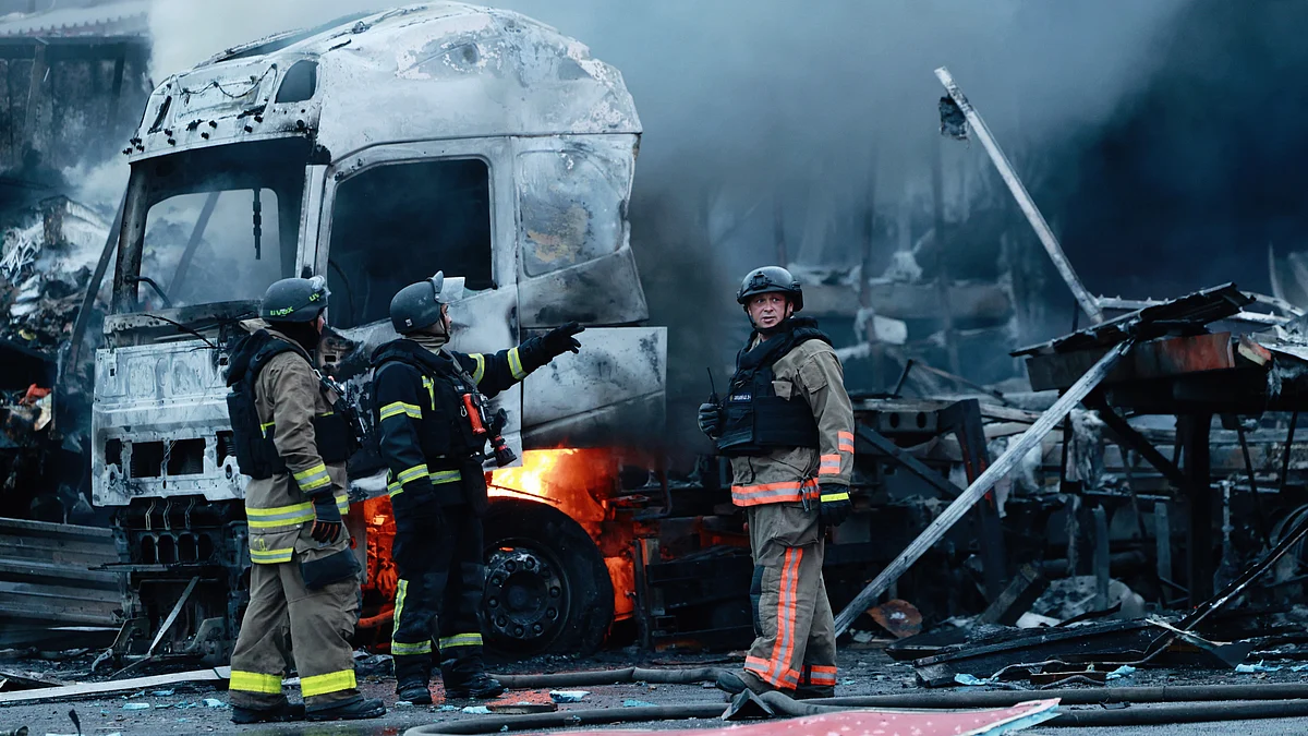 Rescue workers at a mail sorting centre after a Russian strike in Zaporizhzhia, Ukraine, 25 July
